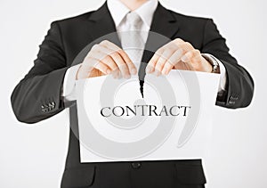 Man hands tearing contract paper
