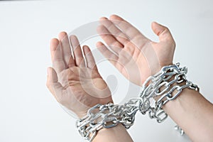 Man hands are tied with chain on white background