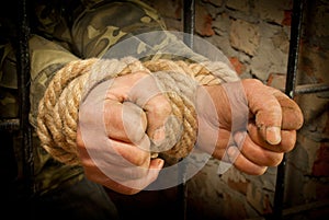 Man with hands tied with rope