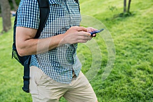 Man hands touching smartphone bright background, closeup