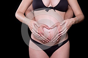 Man hands touching stomach of his pregnant woman