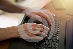 Man hands typing on black computer keyboard