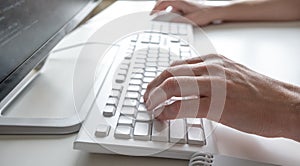 Man hands typing on computer keyboard, business man working on pc in office. Close-up