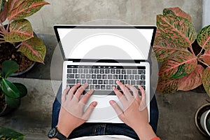 Man hands typing laptop computer with blank screen for mock up t