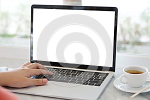 Man hands typing laptop computer with blank screen for mock up t