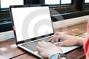 Man hands typing laptop computer with blank screen for mock up t