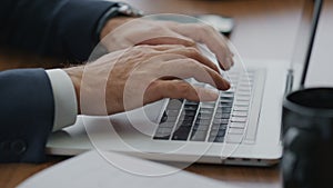 Man hands typing laptop keyboard at desk close up. Businessman using computer.