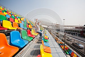 Man with hands up in the seats for spectators