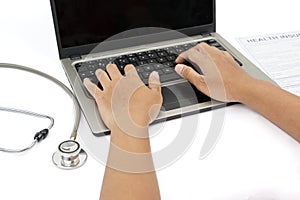 Man hands use laptop to fills health insurance claim