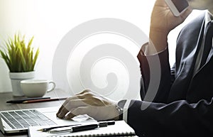Man hands using keyboard of laptop computer on office desk.