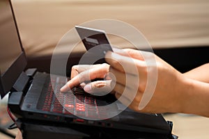 Man Hands using laptop computer and holding credit card. Online shopping and online payment concept