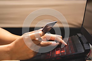 Man Hands using laptop computer and holding credit card. Online shopping and online payment concept