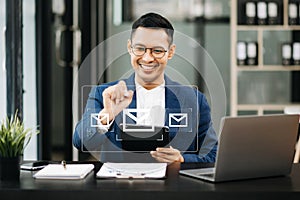 Man hands using Laptop, tablet typing on keyboard and surfing the internet with email icon, email marketing concept, send e-mail