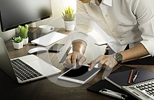 Man hands using tablet and laptop computer on office table desk.