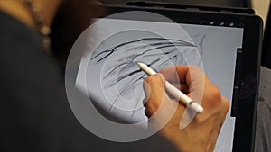 Man hands working on graphic tablet. Designer works on graphic tablet at PC