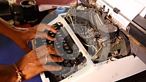 Man hands working on Vintage Manual Typewriter