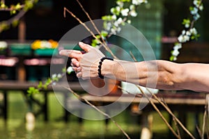 Man hands in yoga symbolic gesture mudra outdoor shot closeup