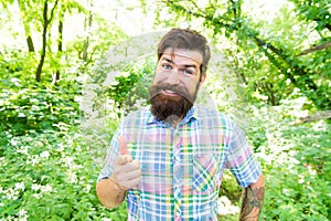 Man handsome beard and mustache in summer forest. United with environment. Summer vacation concept. Explore wild nature