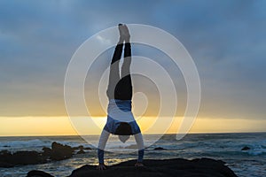 Man Handstand Ocean Rocks Silhouetted