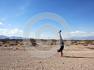 Man Handstanding in the Las Vegas Desert on a clear day