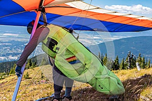 Extremal man with hang-glider preparing to fly photo