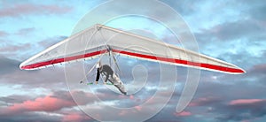 Man hang-gliding at sunset