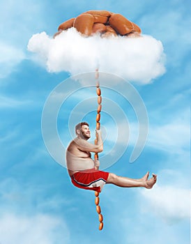 Man hanging on the sausage rope