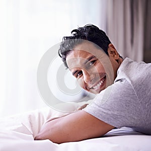 Man, happy and calm in bedroom in portrait, wellness and confident person on morning in home. Young guy, positive face