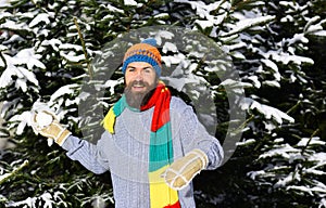 Man happy smiling and throwing snowballs. Winter fun and vacation.