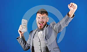 Man happy winner rich hold pile of dollar banknotes blue background. Easy cash loans. Win lottery concept. Businessman