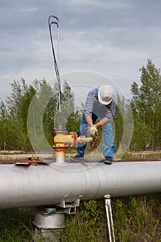 Man in hard hat closed the valve