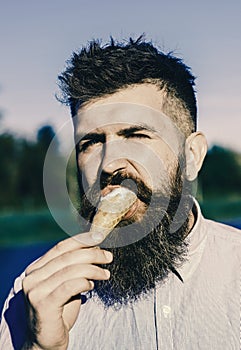 Man has ice cream. Man with long beard enjoy ice cream. Sweet tooth concept. Bearded man with ice cream cone