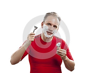 Man has a shave- with the razor and a small brush