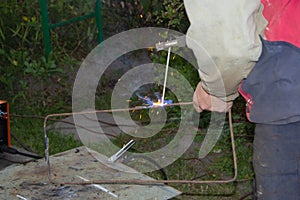 the man has welding equipment in his hands. welding of iron construction.