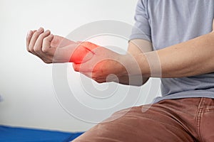 Man has wrist pain from using smartphone or computer for a long time, arthritis, ergonomics,