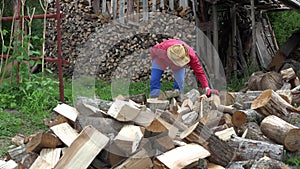 Man with hat chop firewood axe for winter. Work in country. 4K