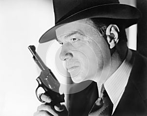 A man with a hat and gun photo