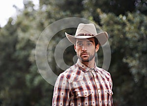 Man, hat and outdoor cowboy fashion, western culture and countryside ranch in Texas. Male person, accessory and flannel