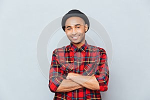 man in hat standing with arms crossed