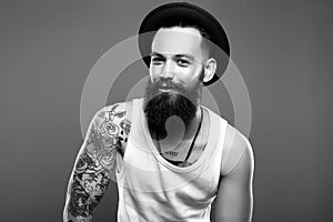 Man in Hat and Tattoo. Smiling Hipster boy