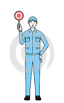 Man in hat and work clothes holding a maru placard that shows the correct answer