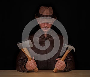 Man with hatchet and hammer