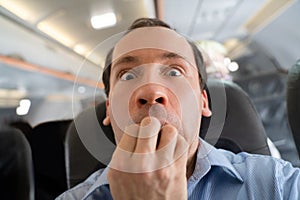 Man Having Anxiety Attack In Airplane