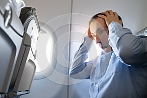 Man Having Anxiety Attack In Airplane