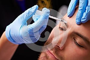 Man Having Botox Treatment At Beauty Clinic