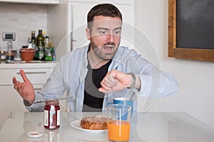 Man having breakfast but too late to go to work