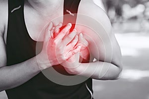 Man having chest pain while exercising - heart attack outdoor. or Heavy exercise causes the body to shock heart disease.