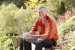 Man Having Coffee Break Whilst Working Outdoors