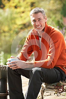 Man Having Coffee Break Whilst Working Outdoors