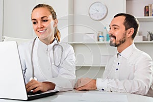 Man having consultation with female doctor in hospital